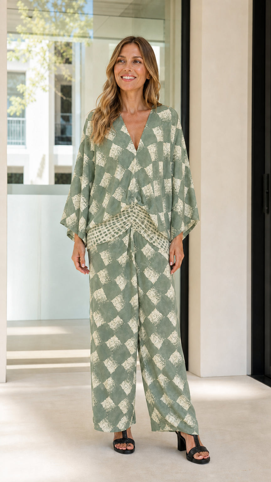Woman wearing sage green geometric print two-piece set