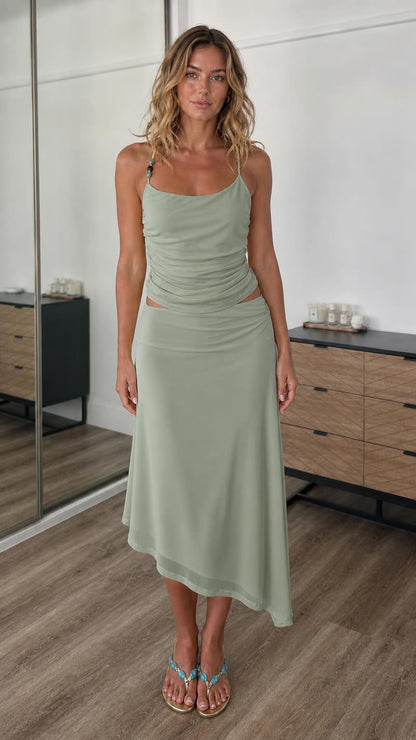 Front view of model wearing sage green two-piece cami top and midi skirt set