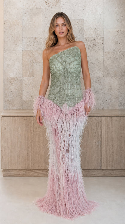 Sage green beaded one-shoulder gown with pink feather skirt and cuffs