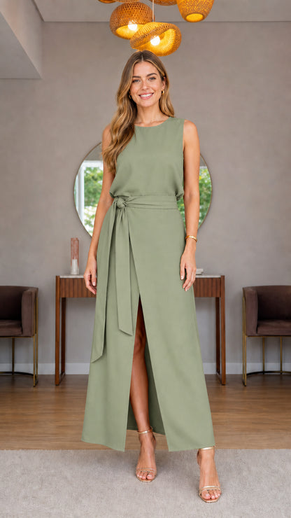 Model wearing sage green sleeveless belted maxi dress with front slit