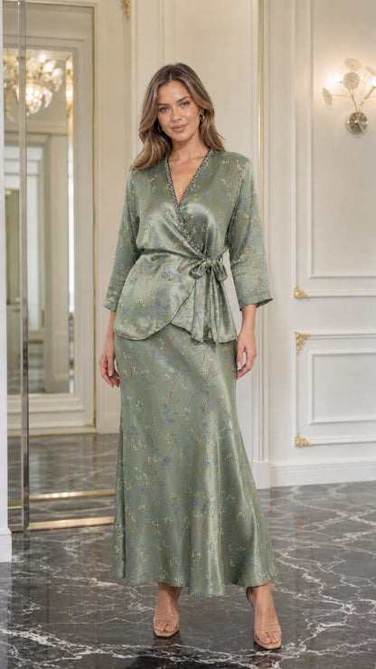 Model wearing sage green satin floral two-piece set
