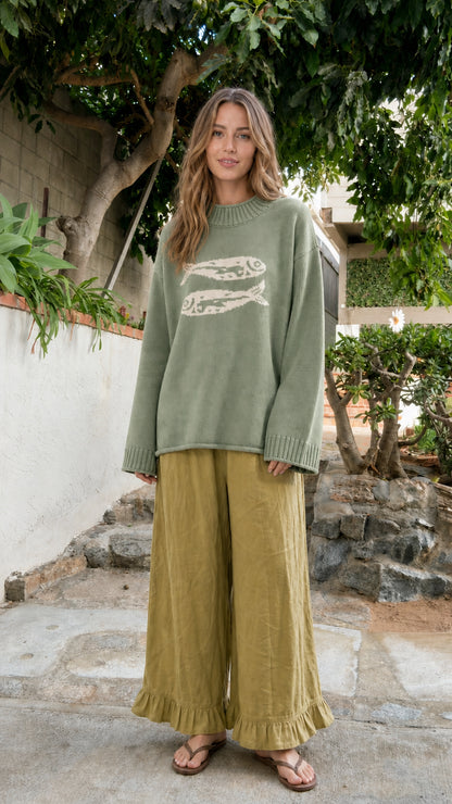 Front view of model wearing Sage Green fish motif crewneck knit sweater