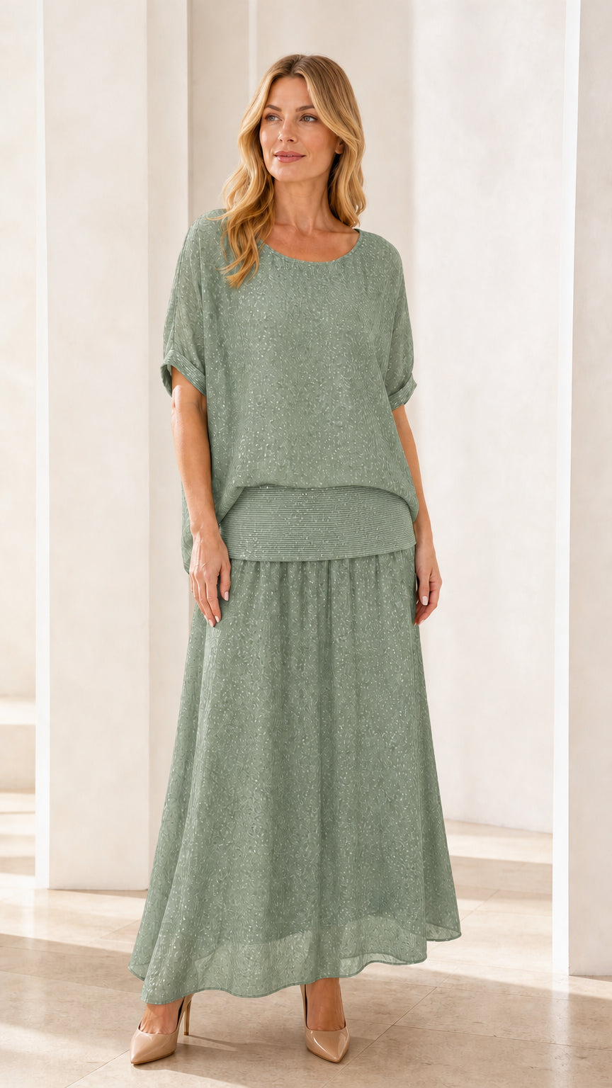 Model wearing sage green shimmer two-piece maxi skirt set