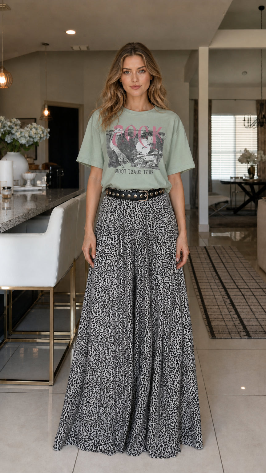 Model wearing sage green graphic tee and leopard print pants