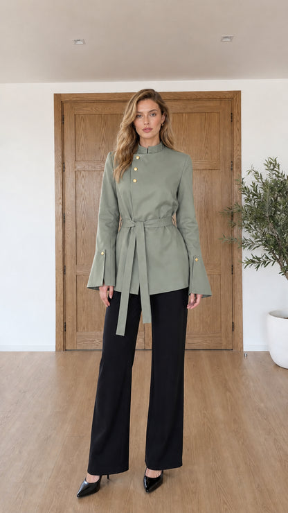 Model wearing sage green asymmetrical belted tunic jacket