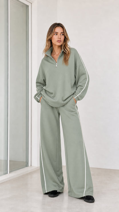 Model wearing sage green half zip pullover and wide leg pants tracksuit set