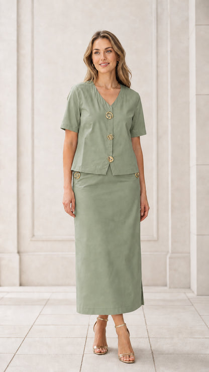 Front full view of woman wearing sage green short sleeve blouse and maxi skirt set