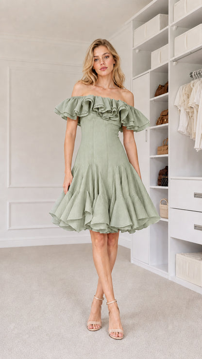 Front view of model wearing sage green off-shoulder dress