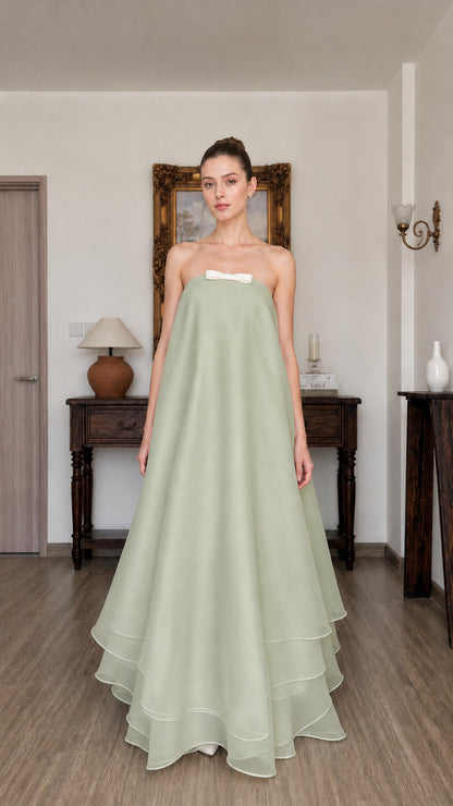 Woman wearing sage green strapless tiered long dress