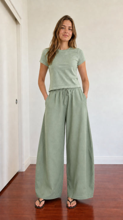Model wearing monochrome sage green wide leg pants and matching green crewneck t-shirt