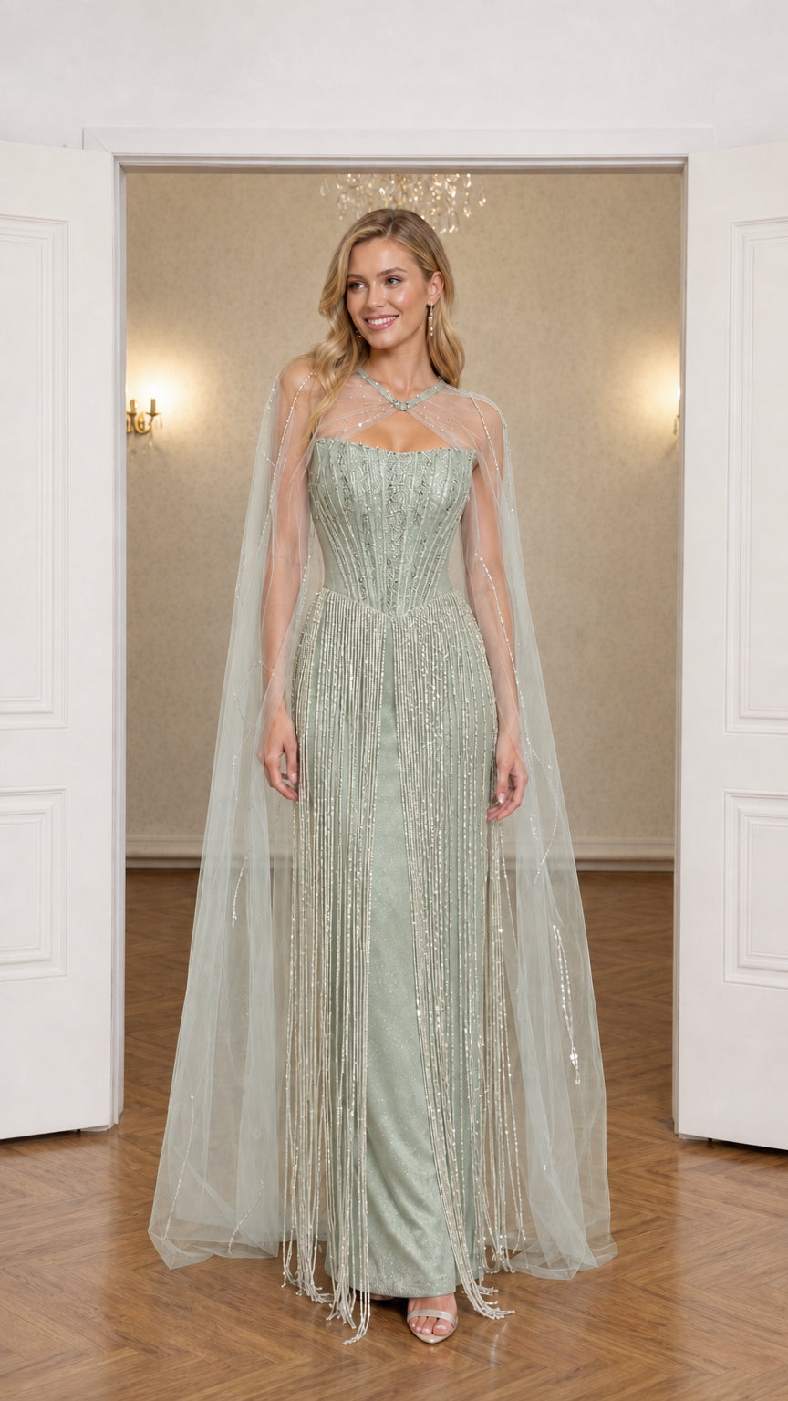 Front view of sage green beaded fringe evening gown with tulle cape