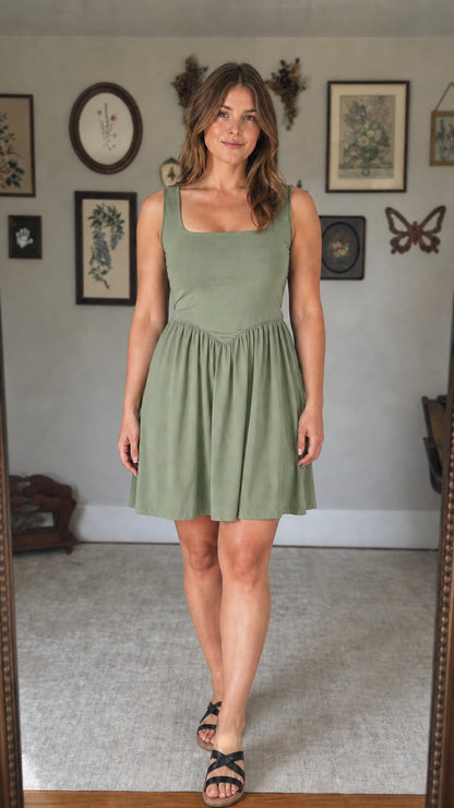 Front view of woman wearing sage green mini dress