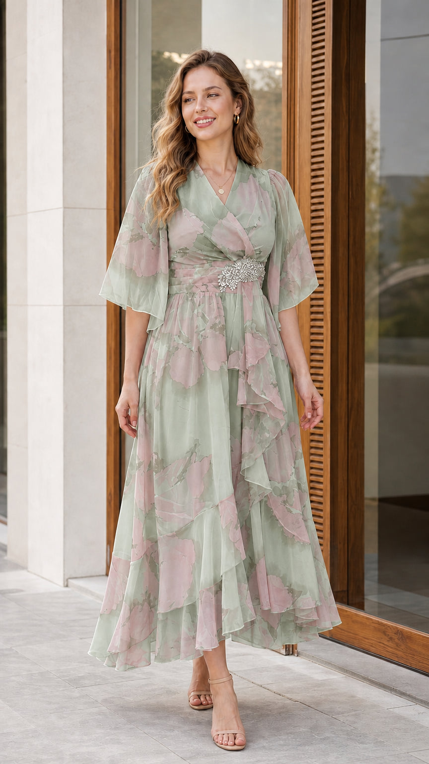 Woman wearing sage green floral chiffon flutter sleeve midi dress with crystal accent