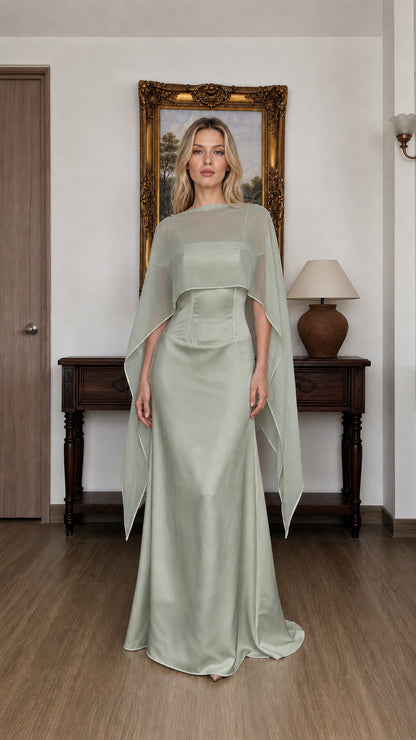 Front view of woman wearing sage green cape overlay evening dress