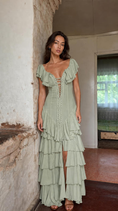 Front view of model wearing sage green ruffle tiered maxi dress
