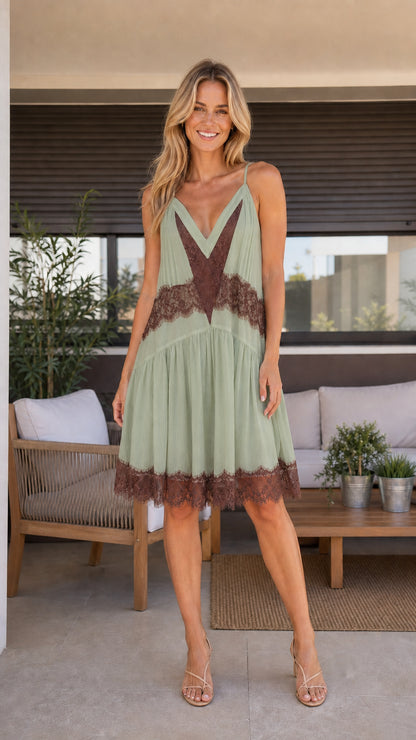 Front view of sage green pleated camisole dress with contrast brown lace trim