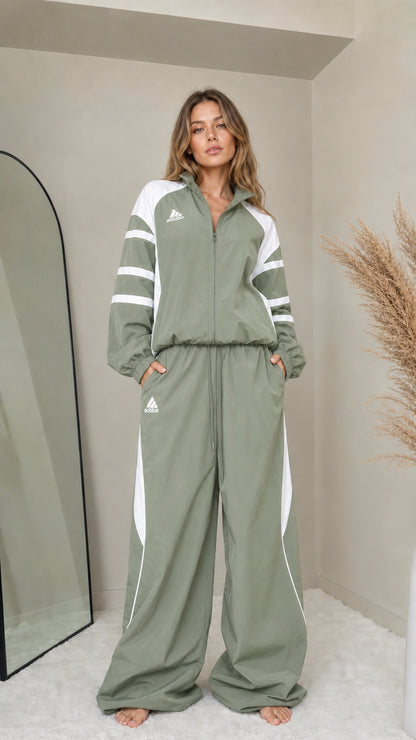 Front full-length view of woman wearing sage green colorblock tracksuit set
