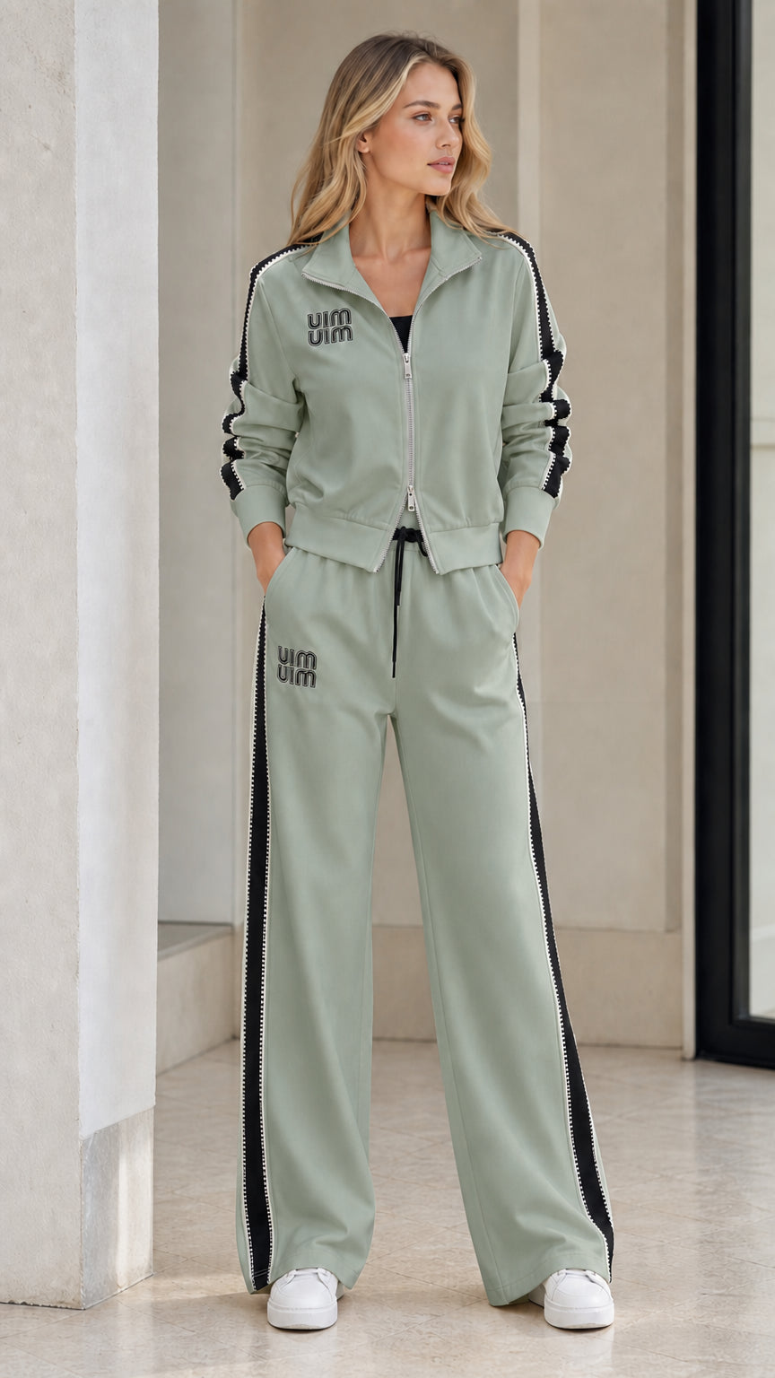 Model wearing Sage Green zip-up track jacket and matching wide-leg trousers set