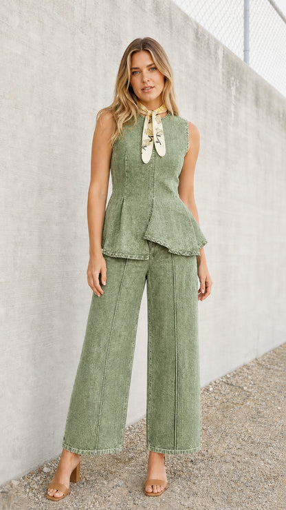 Front view of model wearing green denim peplum top and wide-leg pants set