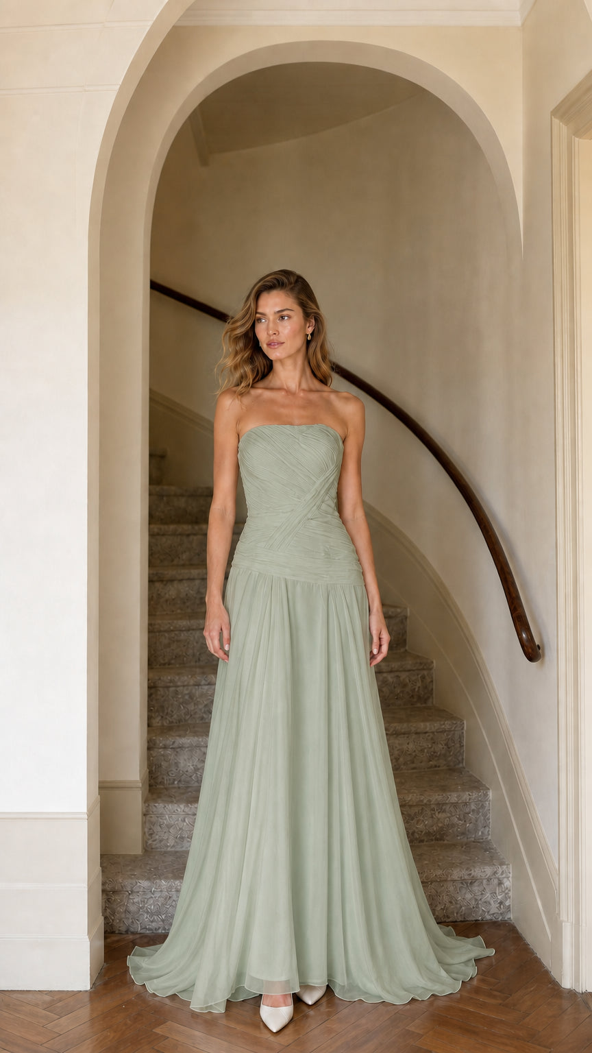 Model wearing sage green strapless ruched chiffon evening gown