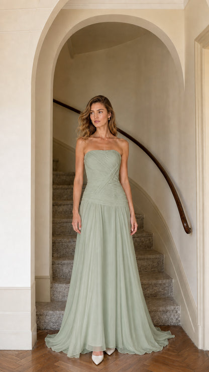 Model wearing sage green strapless ruched chiffon evening gown