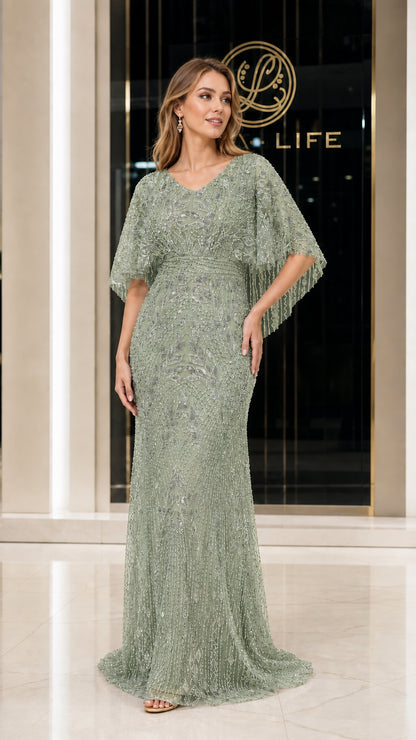 Front view of woman wearing sage green beaded evening gown