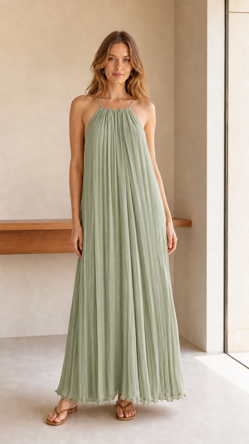 Model wearing sage green pleated halter maxi dress