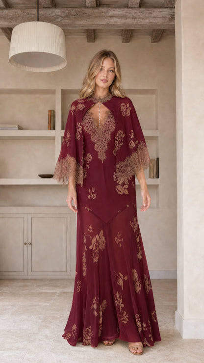 Model wearing burgundy floral maxi dress with cape sleeves