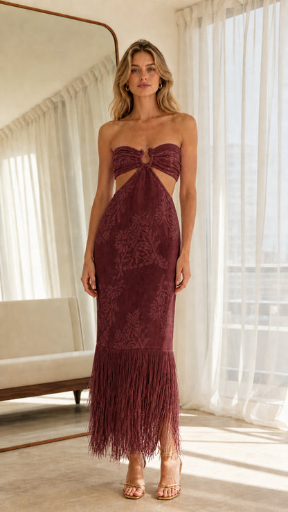Front view of model wearing burgundy strapless cutout midi dress