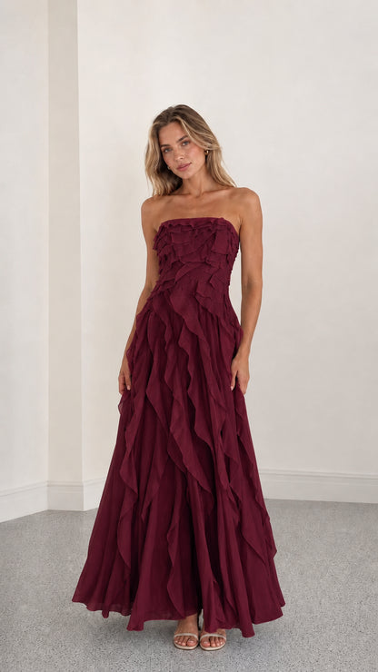 Full length view of burgundy strapless ruffle maxi dress