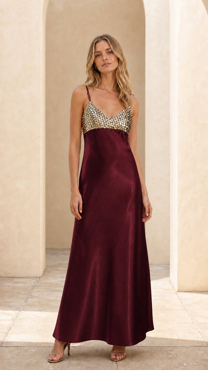 Model wearing burgundy sequin satin maxi dress