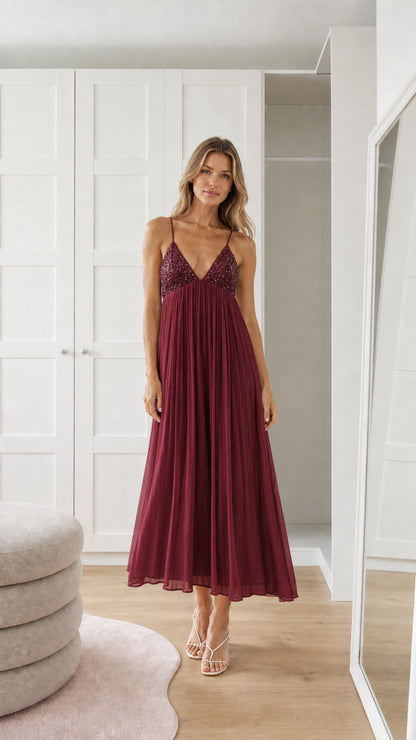 Front view of model wearing burgundy sequin pleated maxi dress