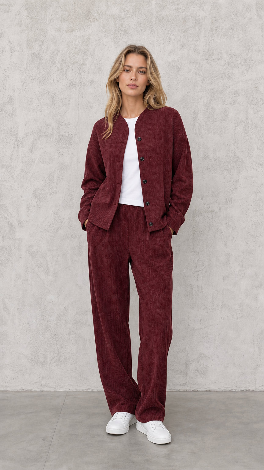 Model wearing Burgundy textured matching two-piece jacket and wide-leg pants set