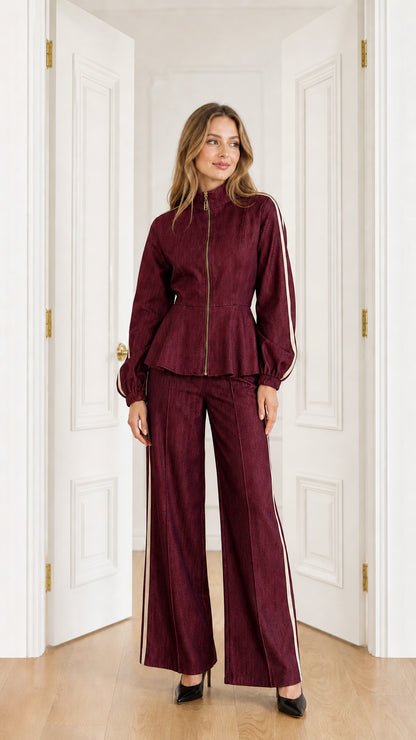 Full-length view of model wearing Burgundy wine peplum jacket and wide-leg pants set with cream side stripes