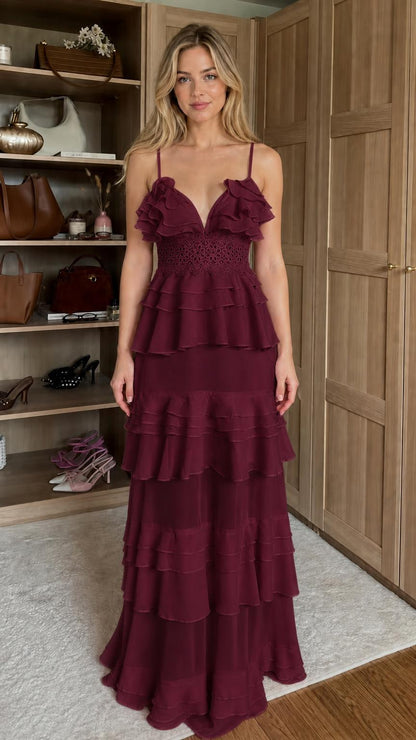 Front view of model wearing burgundy ruffled tiered maxi dress