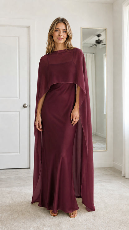 Front full view of woman wearing Burgundy wine capelet formal maxi dress