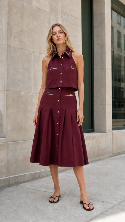 Burgundy sleeveless collared top and pleated midi skirt set shown from the front