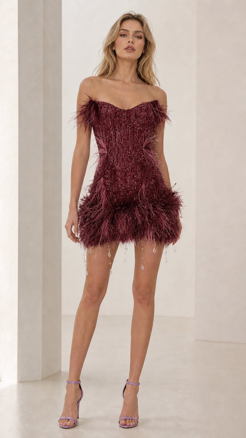 Model wearing burgundy feather trim sequin mini dress