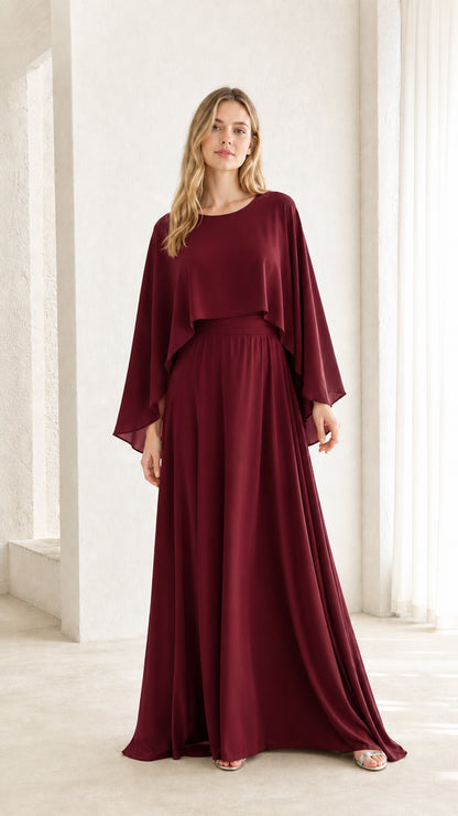 Woman wearing burgundy cape overlay maxi dress