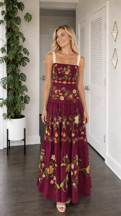 Front view of model wearing burgundy floral embroidered tiered maxi dress