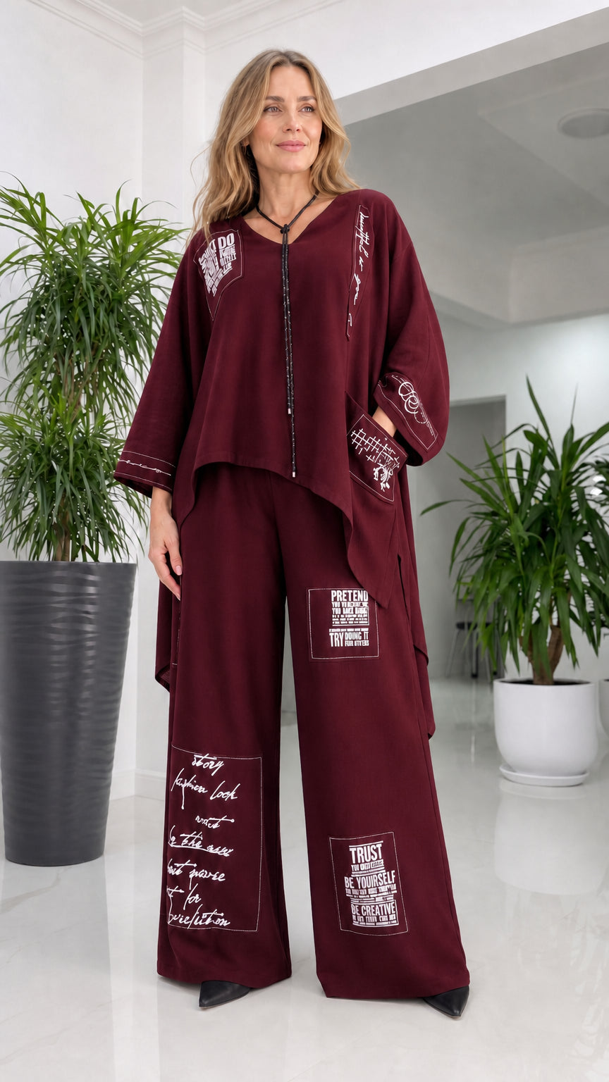 Front view of woman wearing burgundy pant set