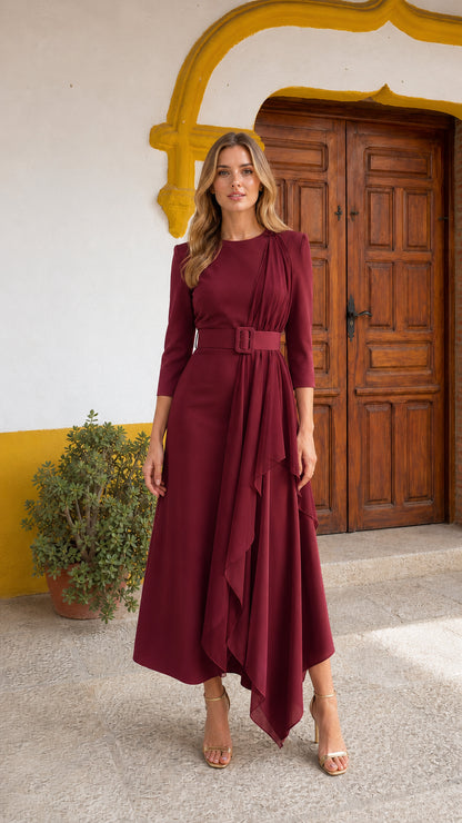 Model wearing burgundy long sleeve ruffle asymmetric belted midi dress