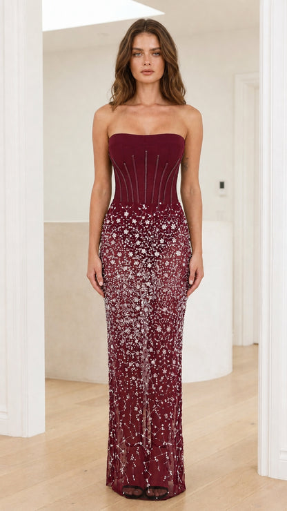 Front view of burgundy strapless sequin sheer maxi dress