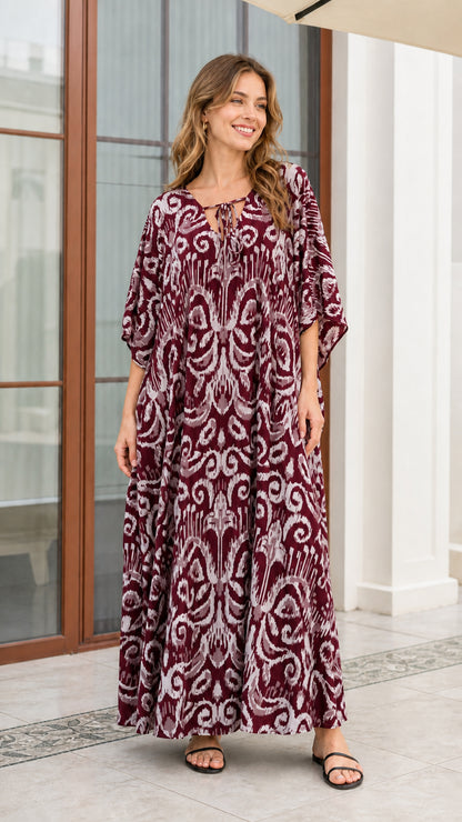 Front view of woman wearing rich burgundy wine printed maxi kaftan dress