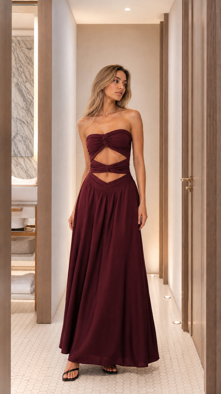 Woman wearing burgundy cutout strapless maxi dress