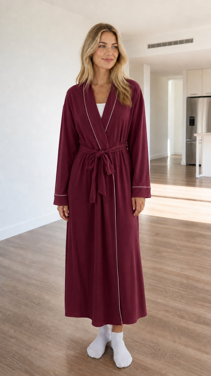 Front view of model wearing burgundy long sleeve robe with contrast trim