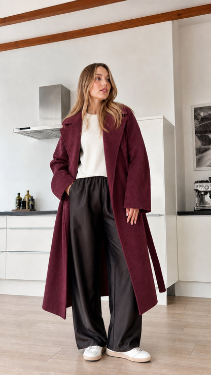 Model wearing burgundy red longline belted coat