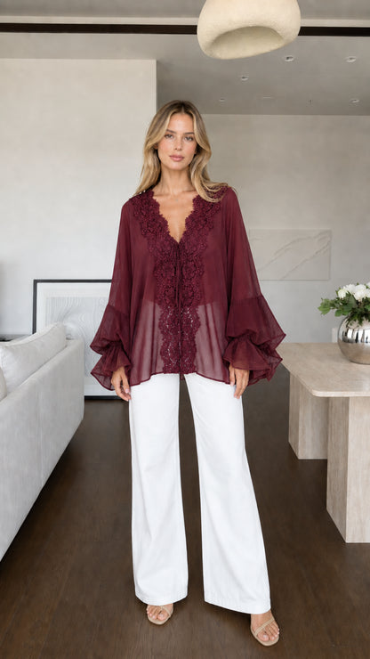 Model wearing burgundy boho lace trim blouse front view