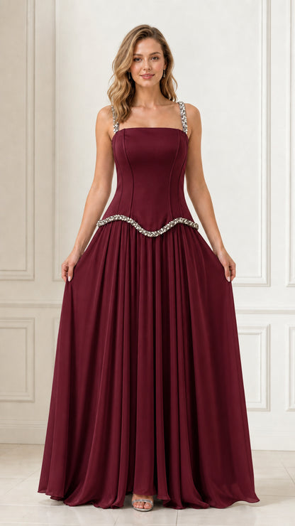Full front view of a woman wearing a burgundy red rhinestone strap formal gown