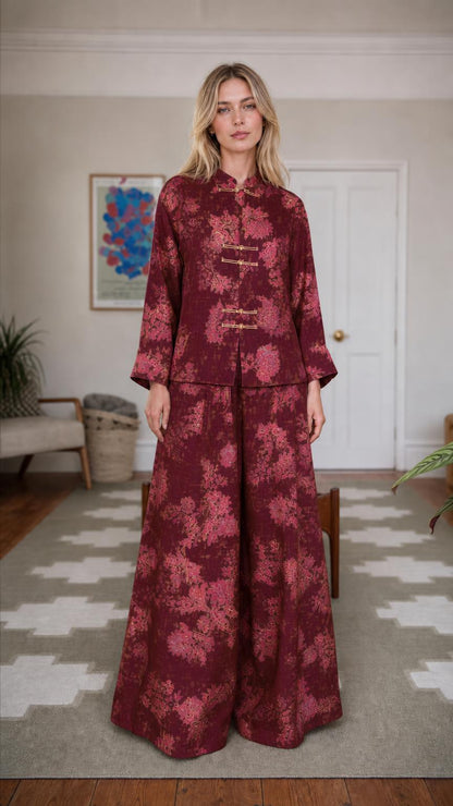 Front view of woman wearing burgundy floral brocade set